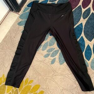 Black capri work out polyester spandex pants with one pocket on right leg.
